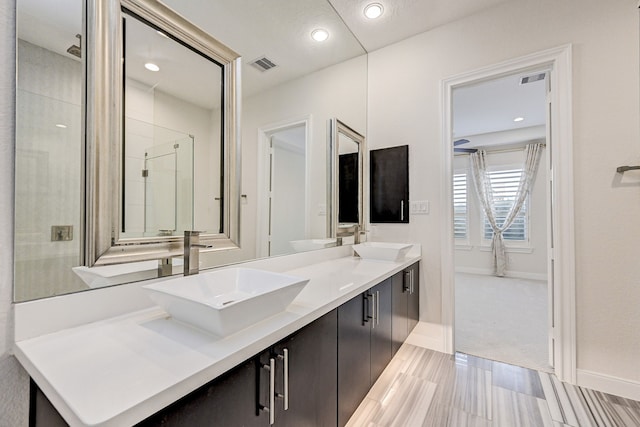 bathroom with an enclosed shower and vanity