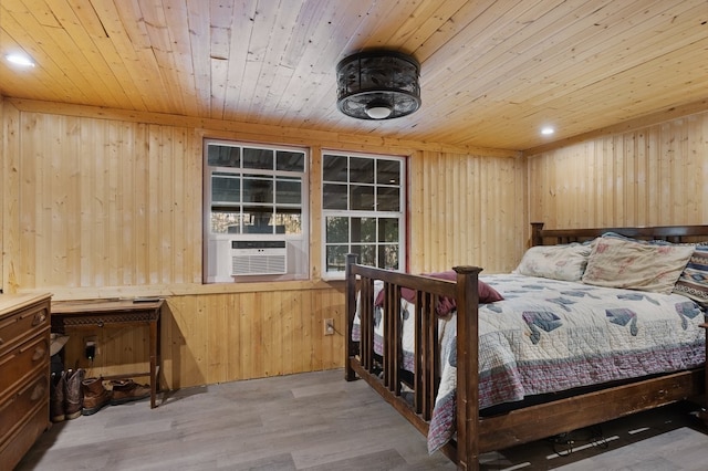 bedroom with cooling unit, wood walls, light wood-type flooring, and wooden ceiling