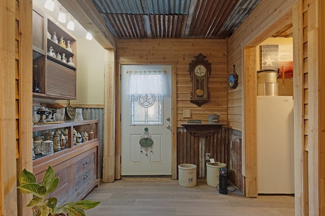 interior space featuring wooden walls and light hardwood / wood-style floors