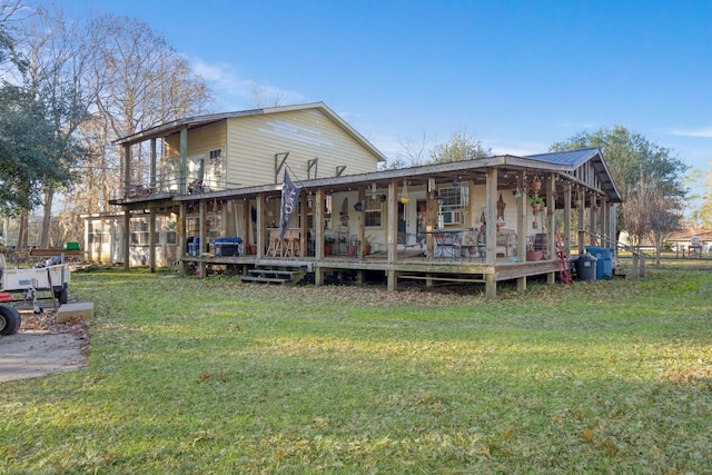 back of property with a wooden deck and a yard