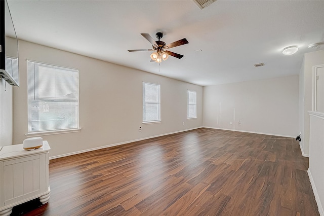 spare room featuring ceiling fan and dark hardwood / wood-style flooring