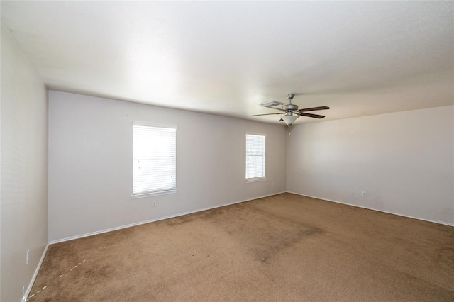 empty room with ceiling fan and carpet flooring