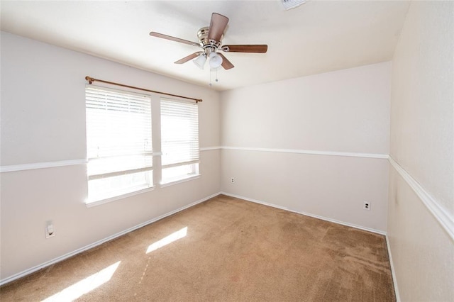 spare room featuring ceiling fan and light colored carpet