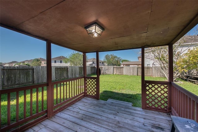 wooden terrace featuring a yard