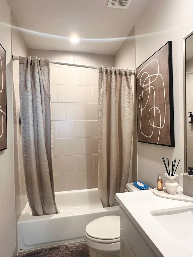 full bathroom with toilet, vanity, and shower / tub combo with curtain