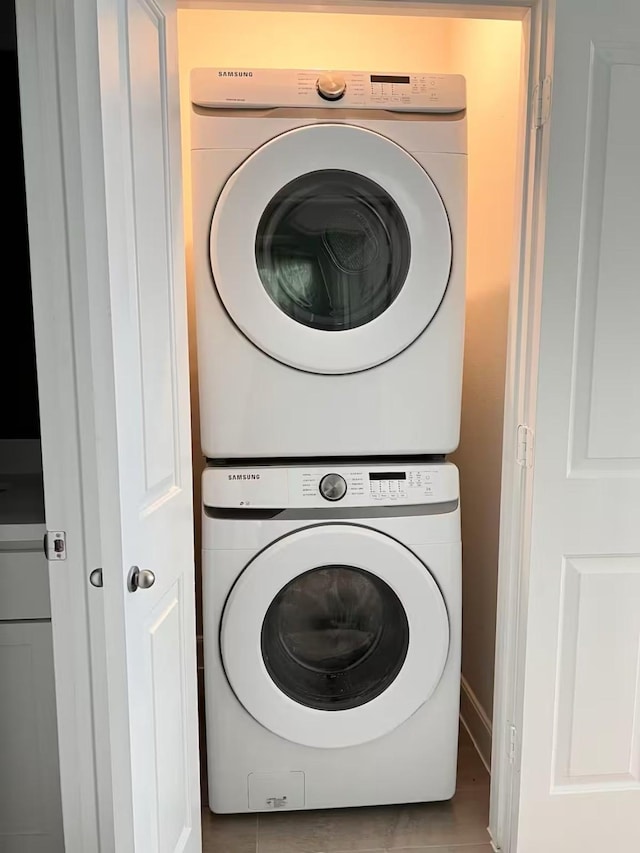 clothes washing area with stacked washer and clothes dryer