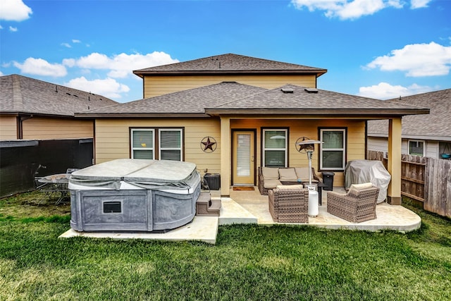 back of house with a patio area, a lawn, and an outdoor hangout area