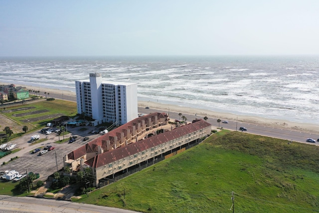 drone / aerial view with a water view and a view of the beach