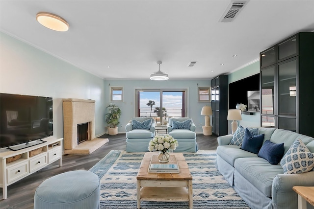 living room with dark hardwood / wood-style floors and ornamental molding