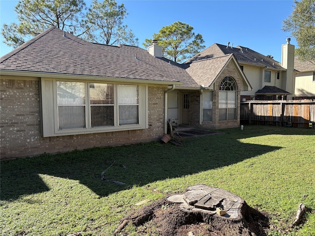 back of house featuring a yard