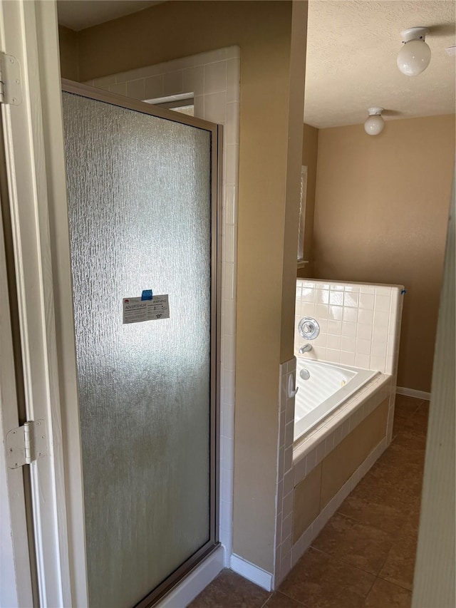 bathroom featuring tile patterned floors and shower with separate bathtub