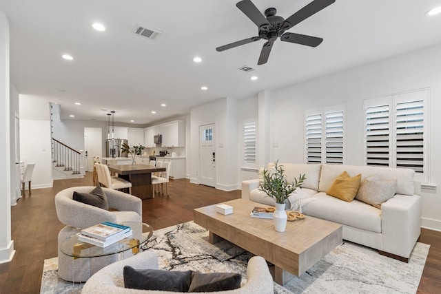 living room with ceiling fan and light wood-type flooring