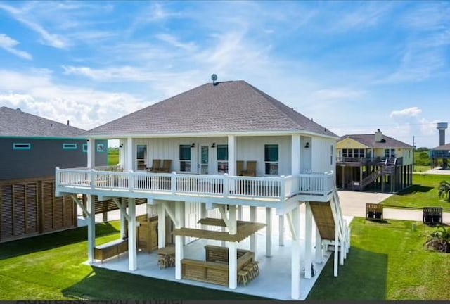 rear view of property featuring a patio area and a yard