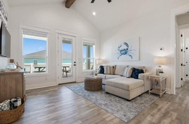 living room with ceiling fan, hardwood / wood-style floors, and lofted ceiling with beams