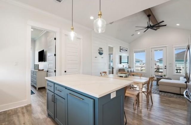 kitchen featuring a center island, vaulted ceiling with beams, pendant lighting, ceiling fan, and dark hardwood / wood-style floors