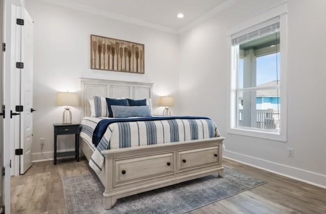 bedroom featuring hardwood / wood-style flooring and crown molding