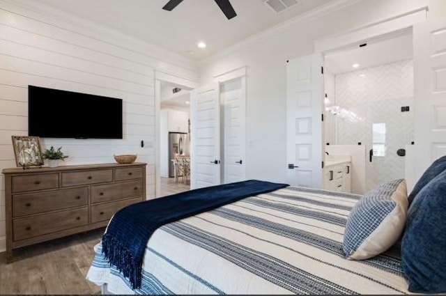 bedroom featuring crown molding, ensuite bath, light hardwood / wood-style flooring, ceiling fan, and stainless steel fridge