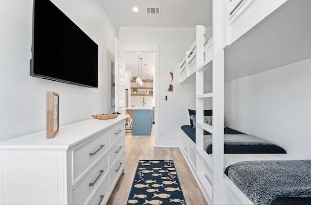 bedroom with light hardwood / wood-style flooring and ornamental molding