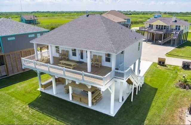 rear view of house with a lawn, a patio, and a deck