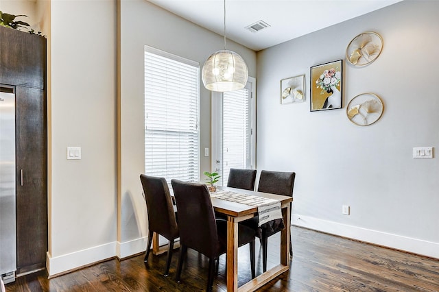 dining area with dark hardwood / wood-style flooring