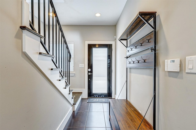 doorway with dark tile patterned floors