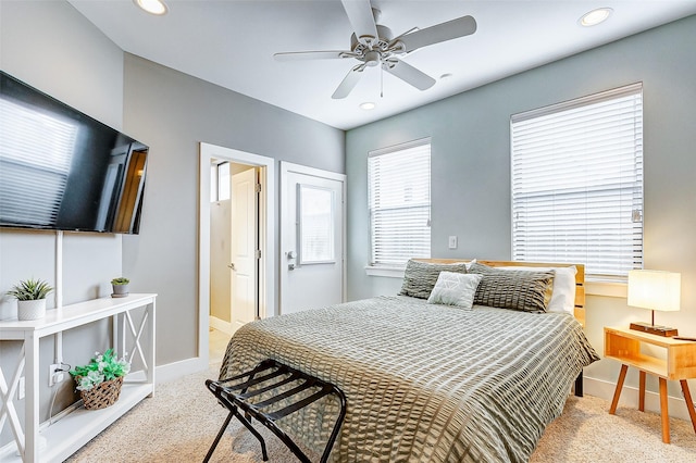 bedroom featuring light colored carpet and ceiling fan