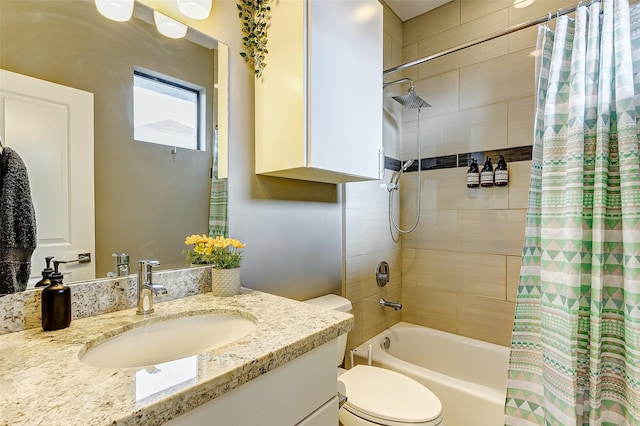 full bathroom featuring toilet, vanity, and shower / bathtub combination with curtain