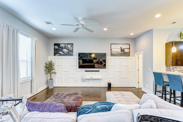 living room with ceiling fan and dark hardwood / wood-style floors