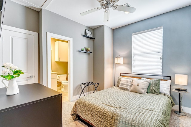 bedroom with connected bathroom, carpet floors, and ceiling fan