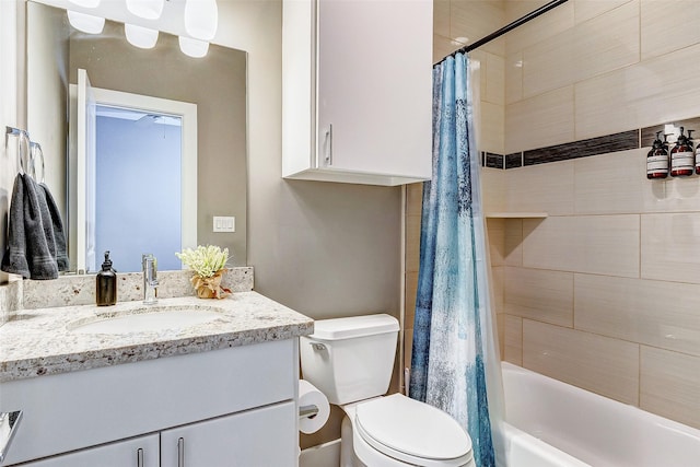 full bathroom with vanity, shower / bath combo, and toilet