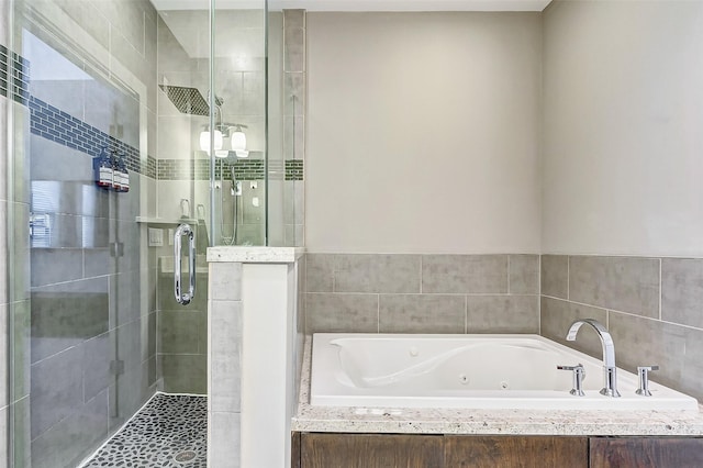 bathroom featuring shower with separate bathtub