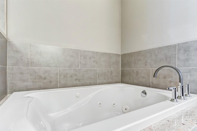 bathroom featuring a relaxing tiled tub