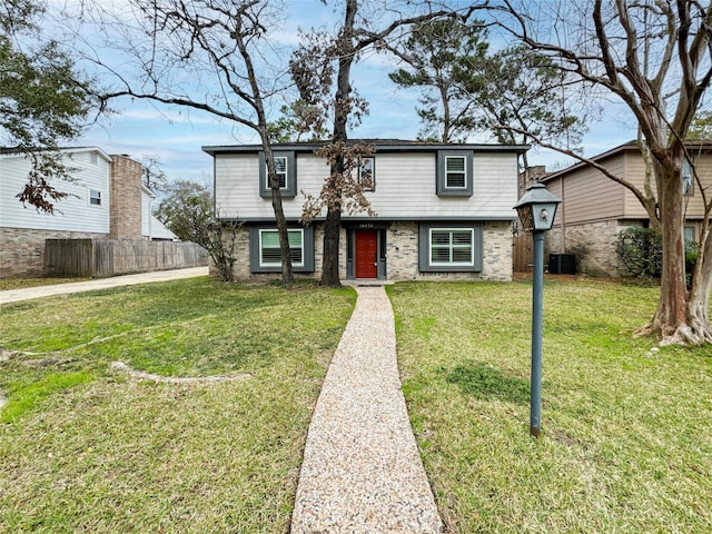 view of front facade featuring cooling unit and a front yard