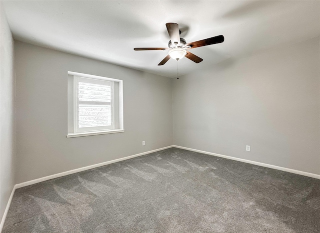 spare room with ceiling fan and carpet