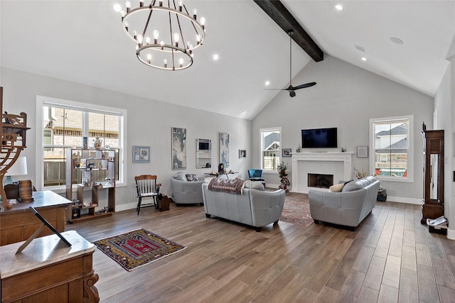 living room with high vaulted ceiling, ceiling fan, a wealth of natural light, and beamed ceiling