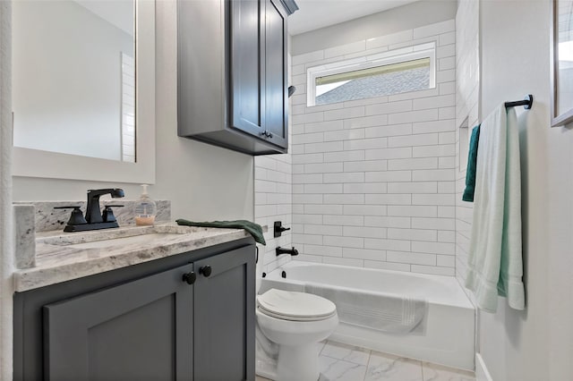 full bathroom featuring toilet, tiled shower / bath, and vanity