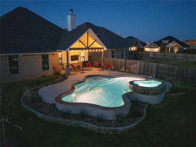 view of swimming pool with an in ground hot tub and a patio