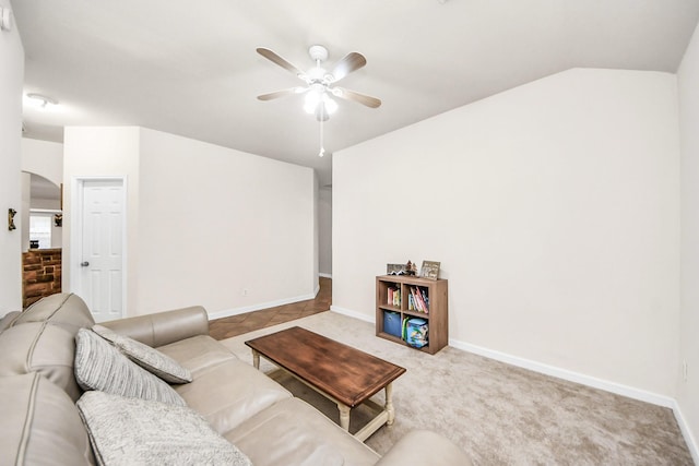 carpeted living room with vaulted ceiling and ceiling fan