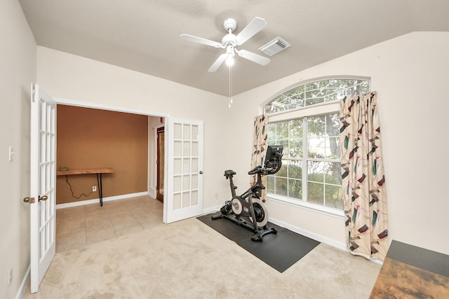 exercise area with lofted ceiling, light carpet, visible vents, a ceiling fan, and french doors