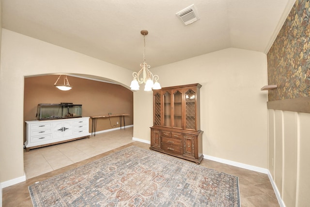 dining space featuring light tile patterned flooring, visible vents, baseboards, vaulted ceiling, and an inviting chandelier