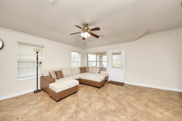 living area featuring visible vents, a ceiling fan, and baseboards