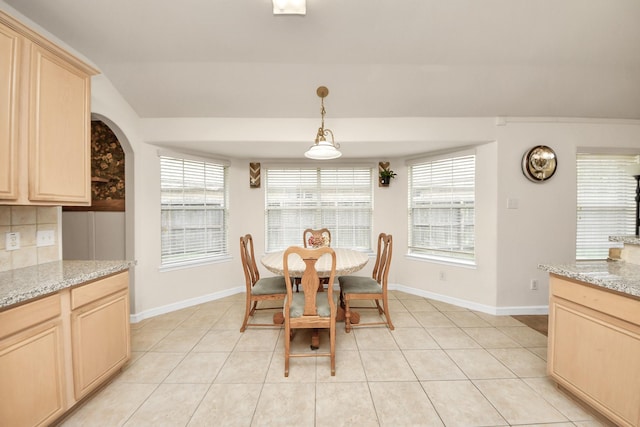 dining room featuring baseboards and light tile patterned floors