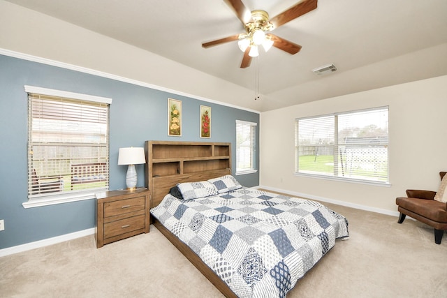 bedroom with baseboards, a raised ceiling, visible vents, and light colored carpet