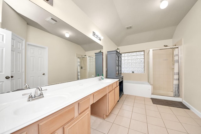 bathroom featuring tile patterned flooring, vaulted ceiling, visible vents, and a sink