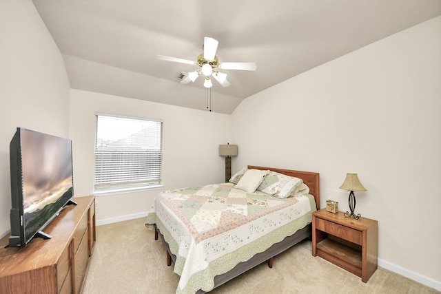 bedroom with light carpet, vaulted ceiling, baseboards, and ceiling fan