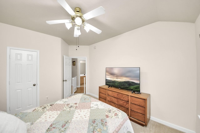 bedroom with a ceiling fan, light carpet, vaulted ceiling, and baseboards