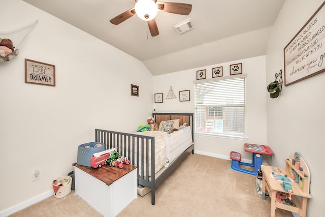 bedroom with light colored carpet, visible vents, lofted ceiling, and baseboards