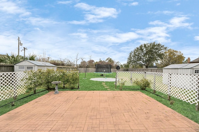 view of patio featuring a fenced backyard and a trampoline