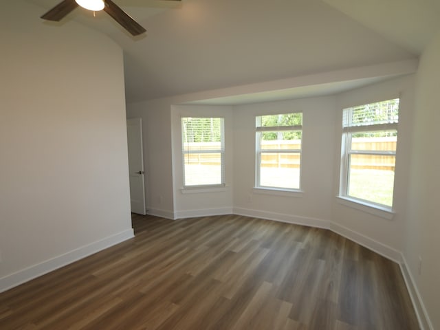 unfurnished room featuring baseboards, a ceiling fan, vaulted ceiling, and dark wood-style floors