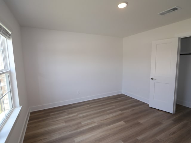 unfurnished bedroom featuring visible vents, recessed lighting, baseboards, and wood finished floors